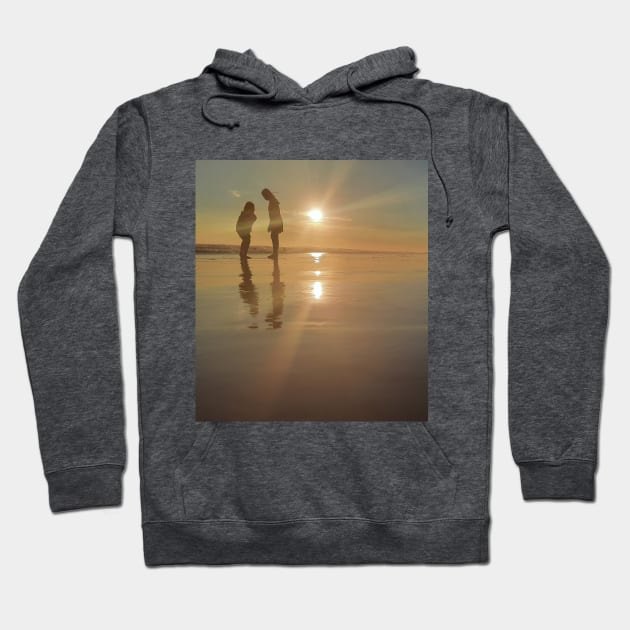 Silhouetted people in a row on a sand beach. Hoodie by kall3bu